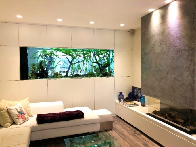 Living room with a large wall-mounted planted aquarium.